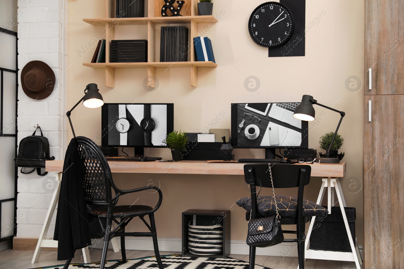 Photo of Stylish workplace interior with computers on table