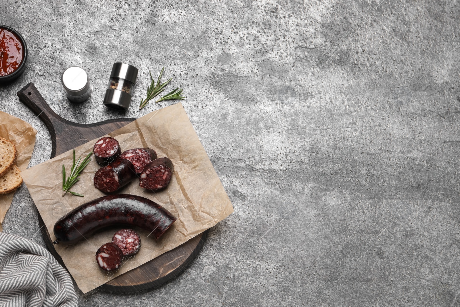 Photo of Tasty blood sausages with rosemary, flat lay. Space for text