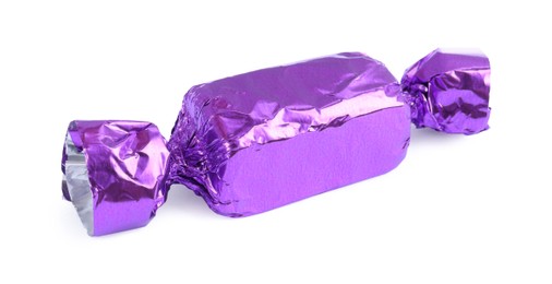 Tasty candy in purple wrapper isolated on white