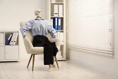 Waiting concept. Human skeleton sitting in armchair at office, space for text