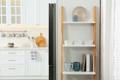 Photo of Decorative wooden ladder in stylish kitchen. Interior design