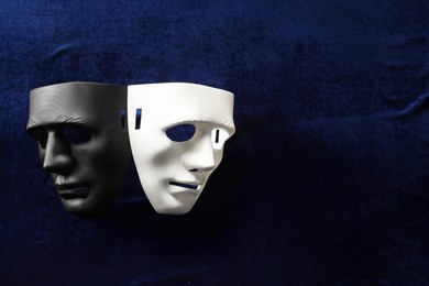 Theater arts. Two masks on blue fabric, top view. Space for text