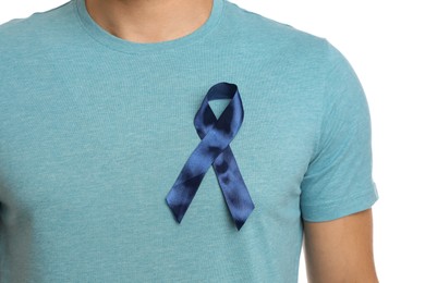 Man with blue ribbon on white background, closeup. Urology cancer awareness