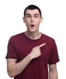 Surprised man pointing at something on white background