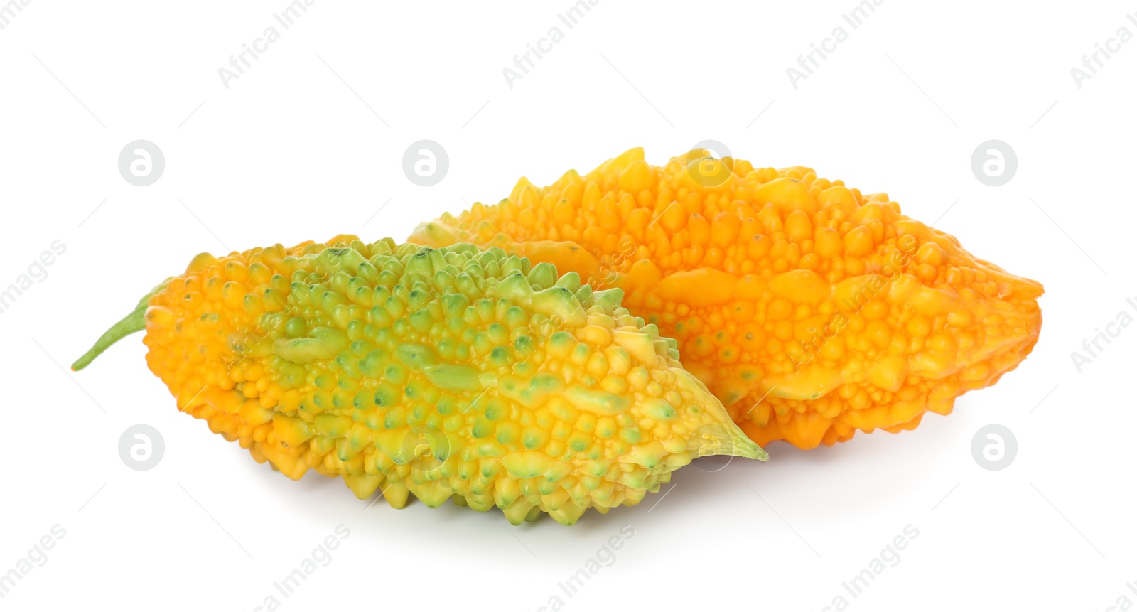 Photo of Fresh ripe bitter melons on white background