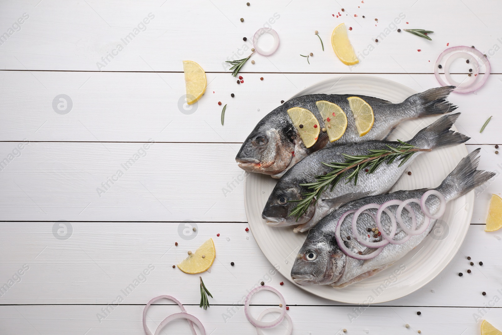 Photo of Flat lay composition with raw dorado fish and spices on white wooden table. Space for text