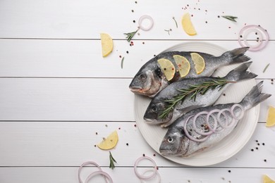 Photo of Flat lay composition with raw dorado fish and spices on white wooden table. Space for text