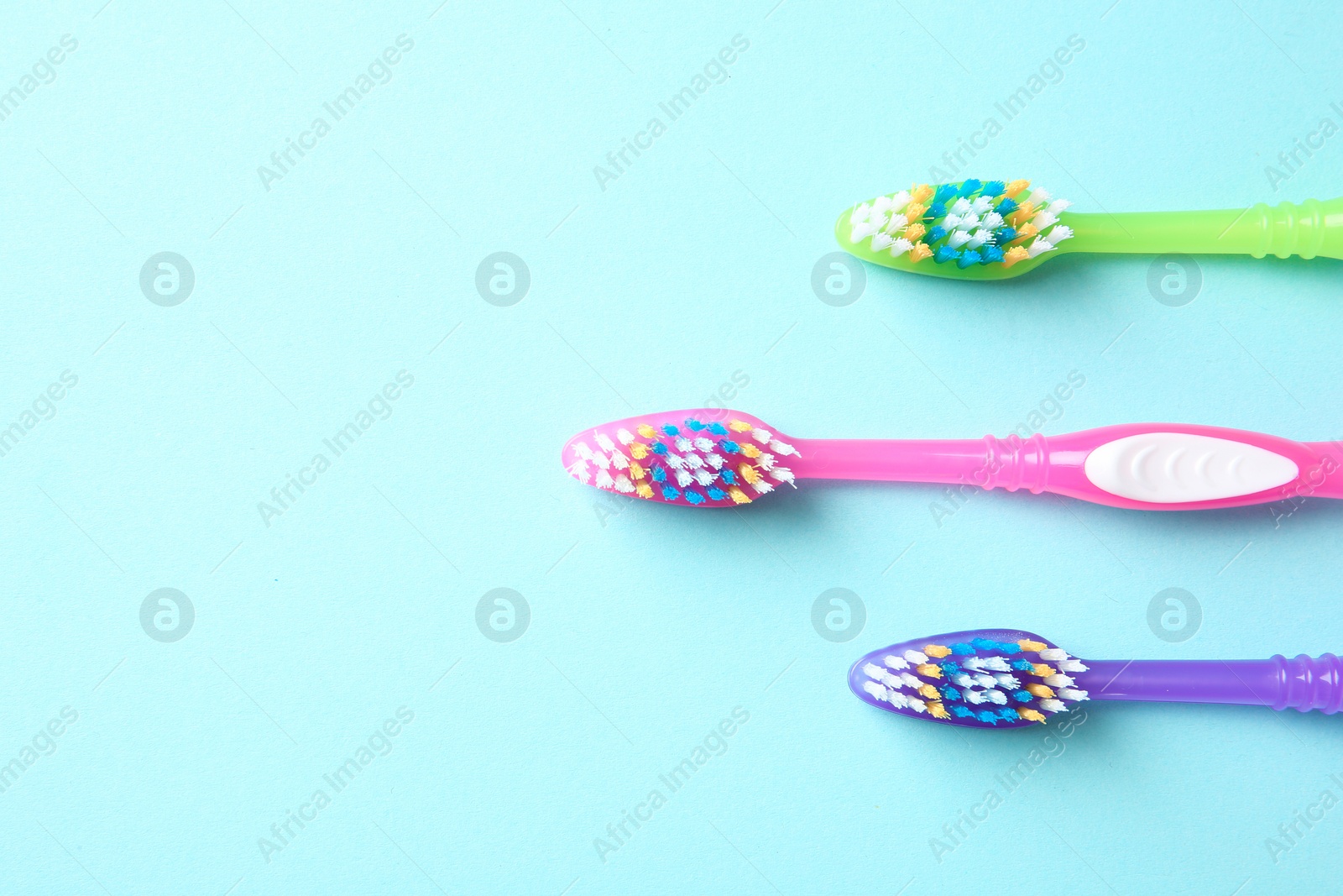 Photo of Flat lay composition with manual toothbrushes on color background