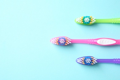 Photo of Flat lay composition with manual toothbrushes on color background