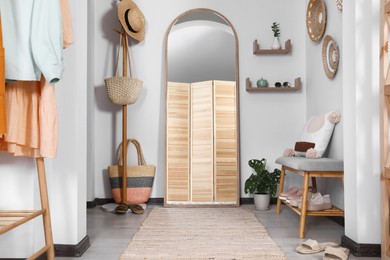 Hallway interior with stylish furniture and floor mirror