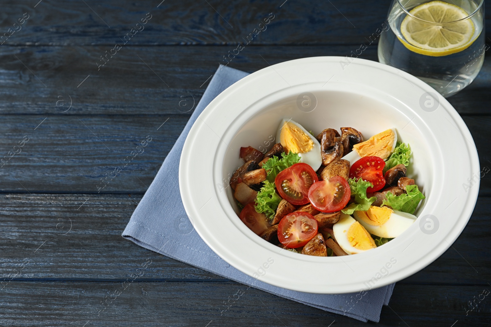 Photo of Plate with delicious fresh salad on table