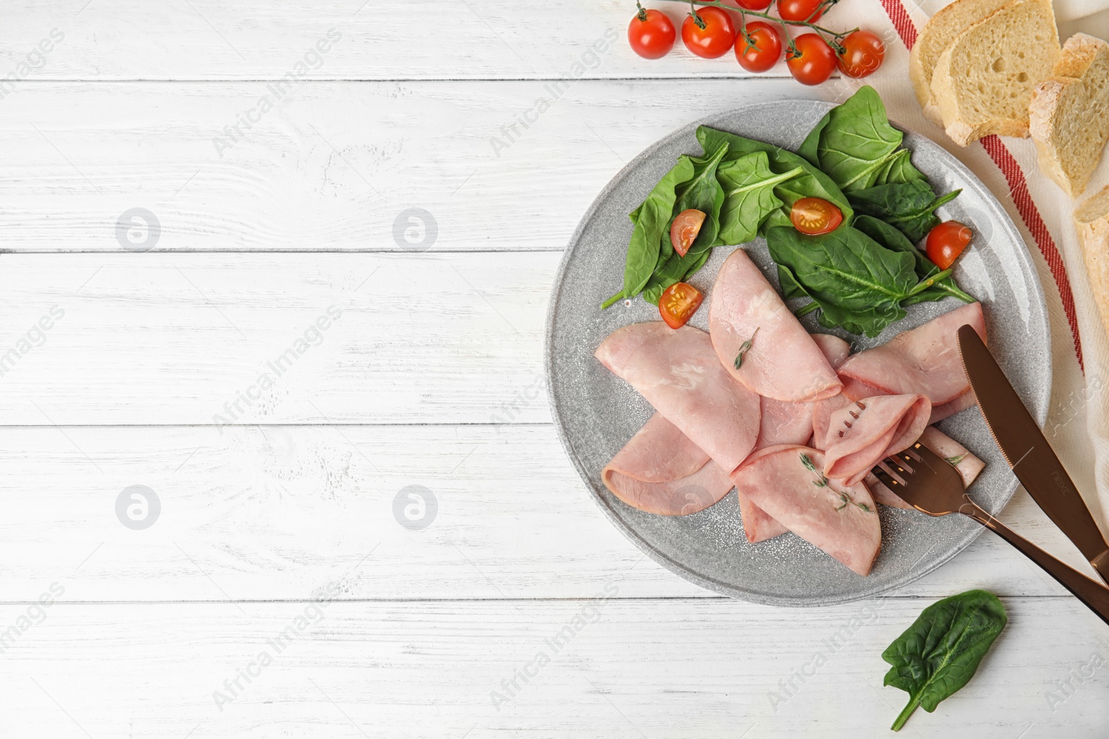 Photo of Tasty ham served on white wooden table, flat lay. Space for text