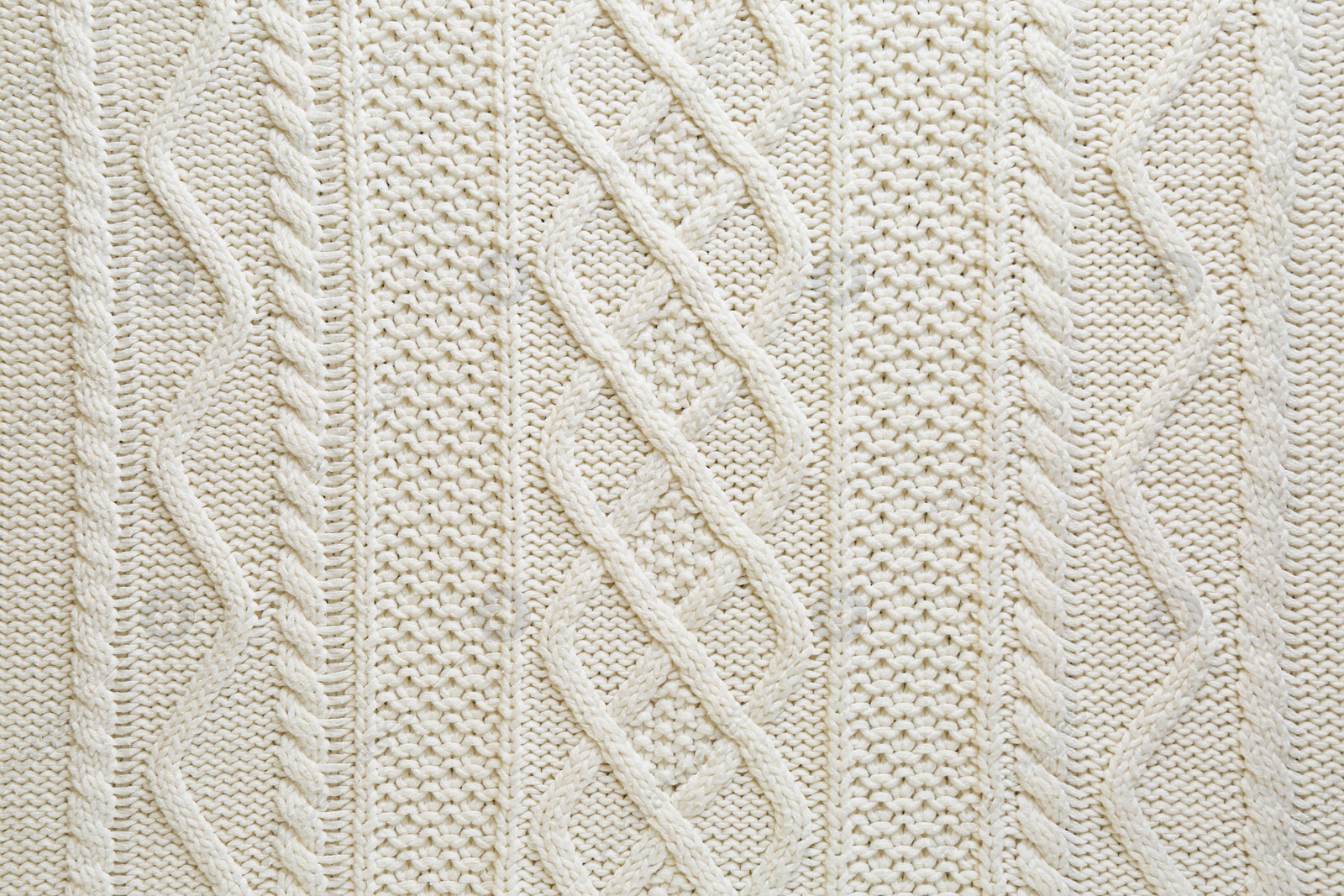 Photo of White knitted fabric with beautiful pattern as background, top view
