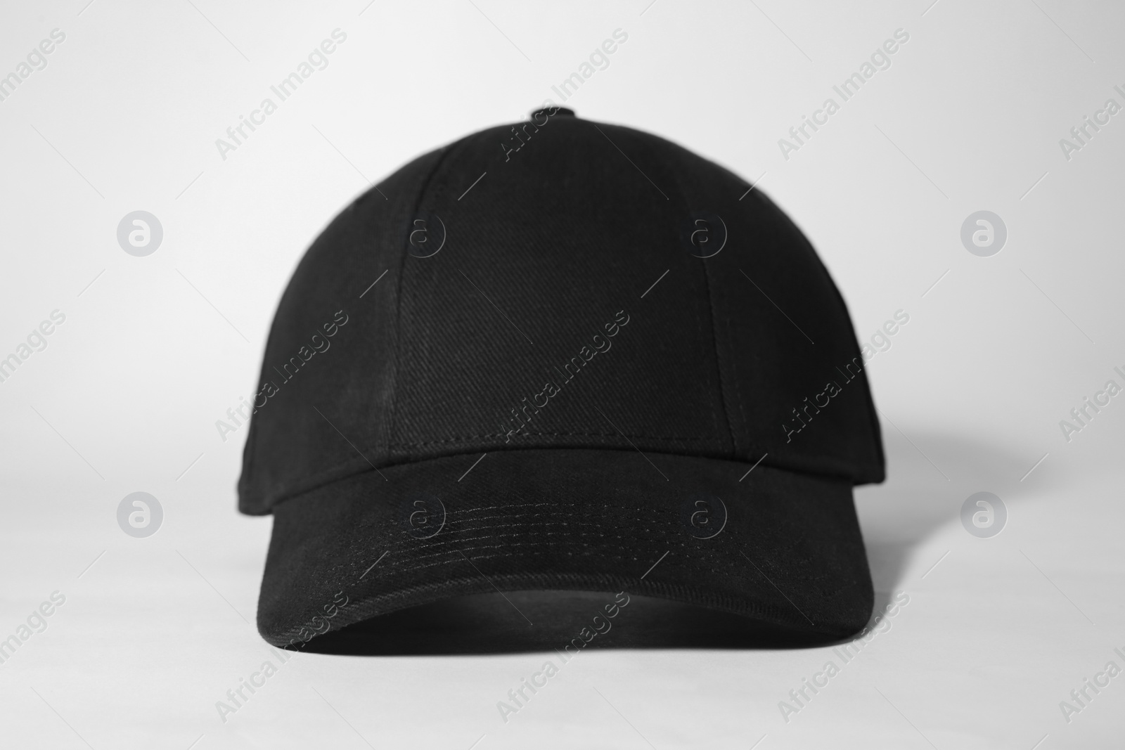 Photo of Stylish black baseball cap on white background