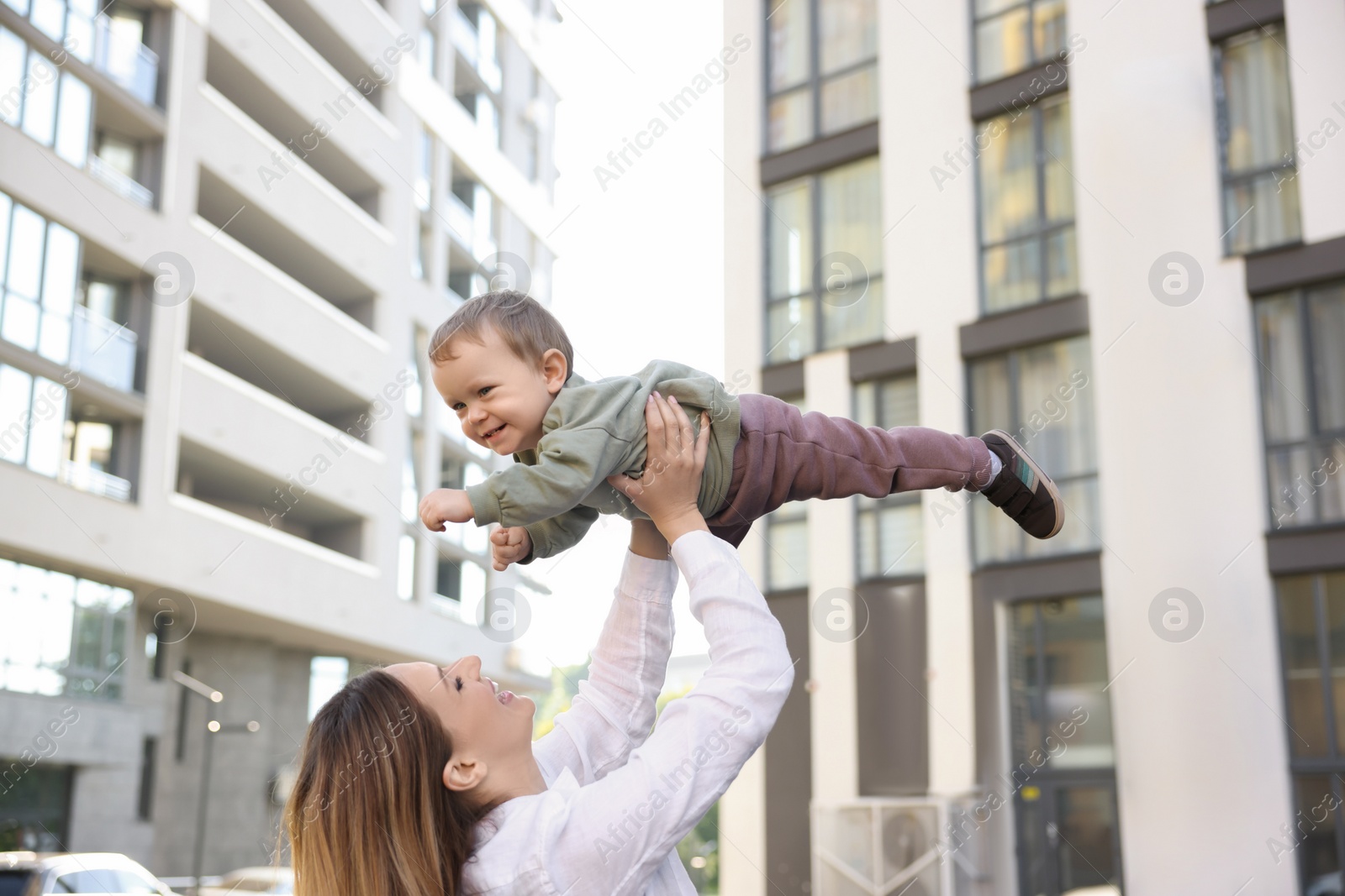 Photo of Happy nanny with cute little boy having fun outdoors