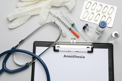 Photo of Flat lay composition of clipboard with word Anesthesia and drugs on light grey background