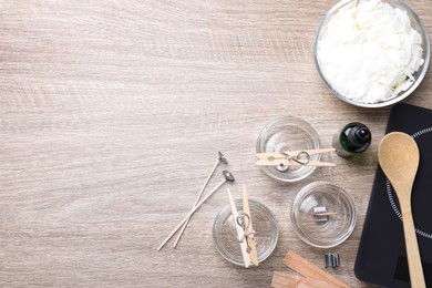 Flat lay composition with homemade candles ingredients on wooden background, space for text