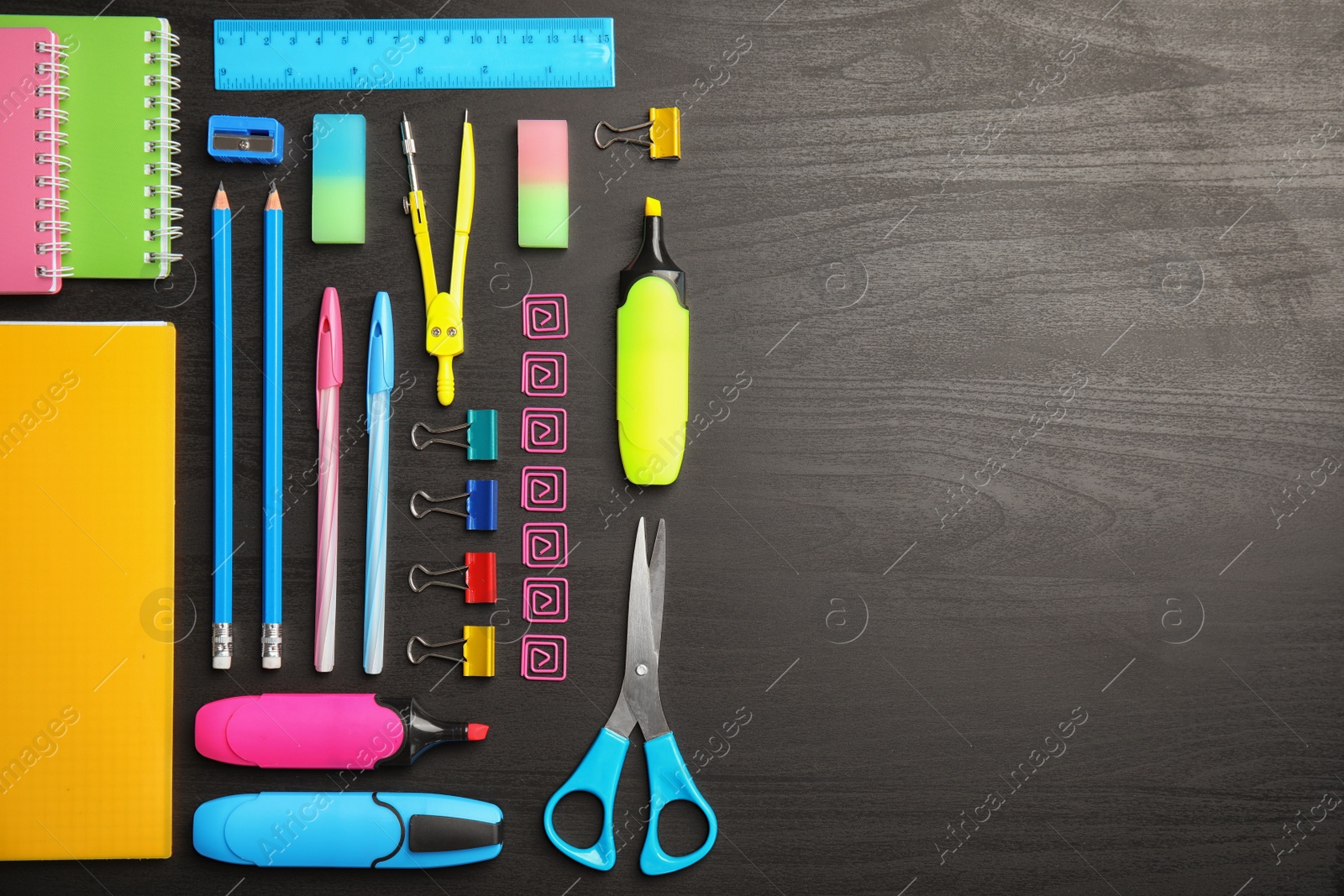 Photo of Different school stationery with space for design on wooden background, flat lay