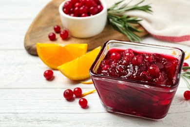 Photo of Cranberry sauce on white wooden table, space for text