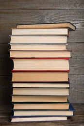 Stack of hardcover books on wooden background