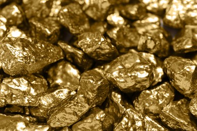 Pile of gold nuggets as background, closeup