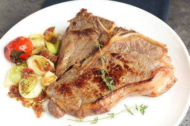 Delicious fried beef meat and vegetables on table, closeup