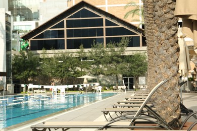 Swimming pool and sunbeds at luxury resort