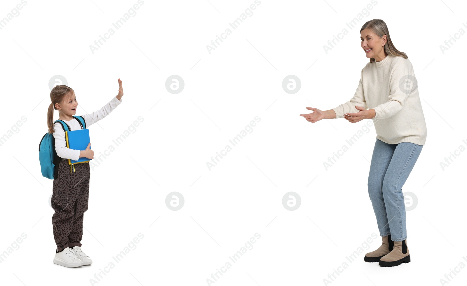 Image of Senior woman meeting her granddaughter after school on white background