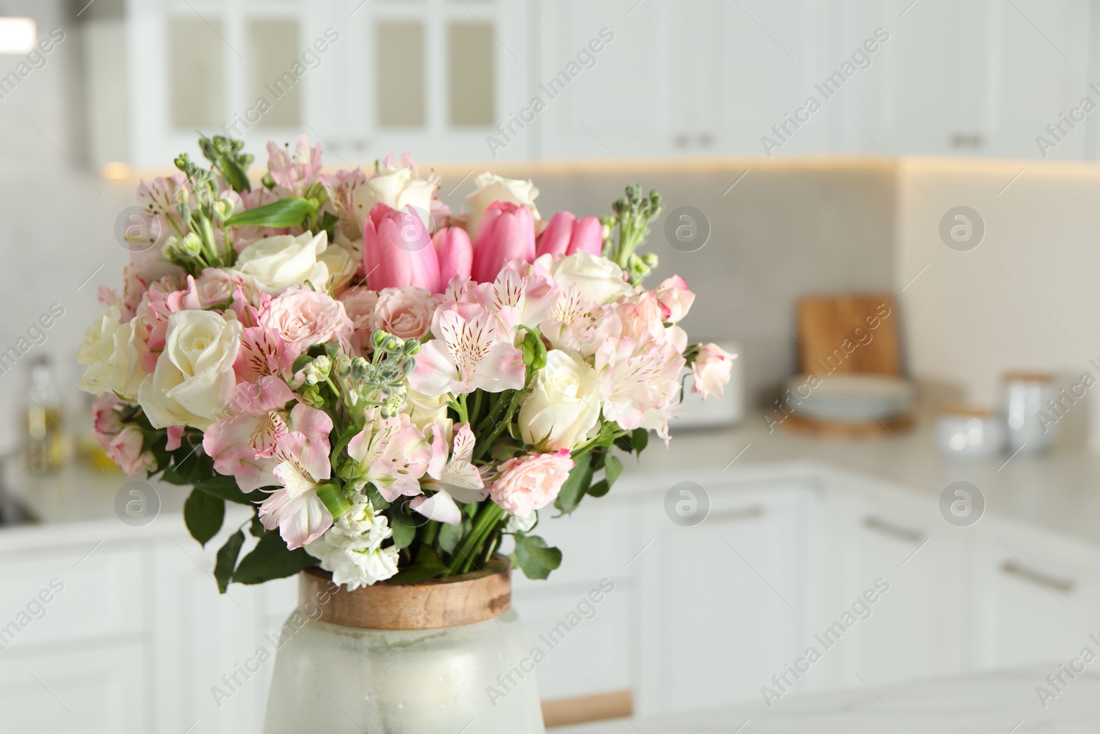 Photo of Beautiful bouquet of fresh flowers in vase indoors