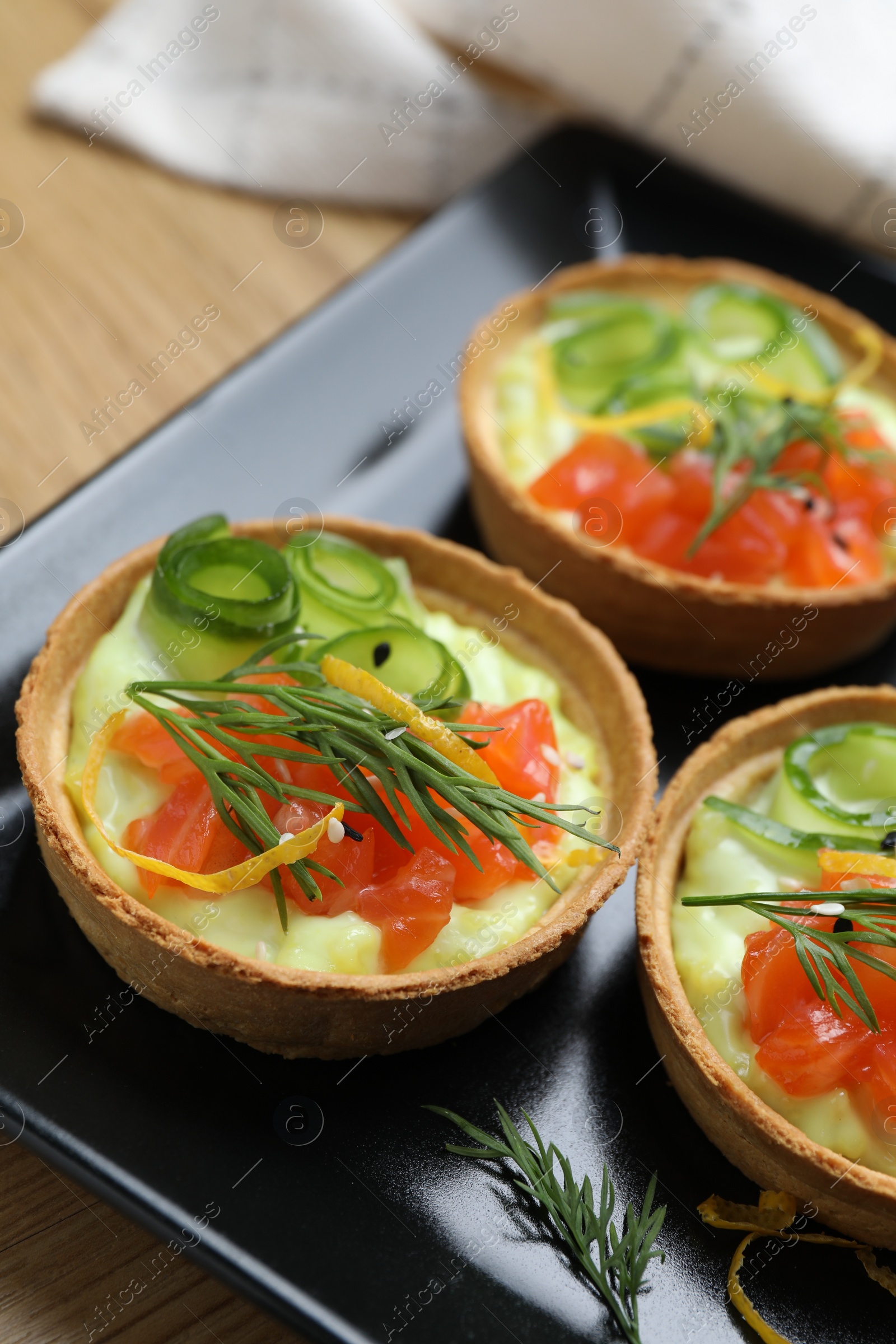 Photo of Delicious canapes with salmon on table, closeup