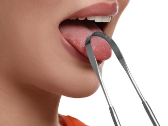 Woman brushing her tongue with cleaner on white background, closeup