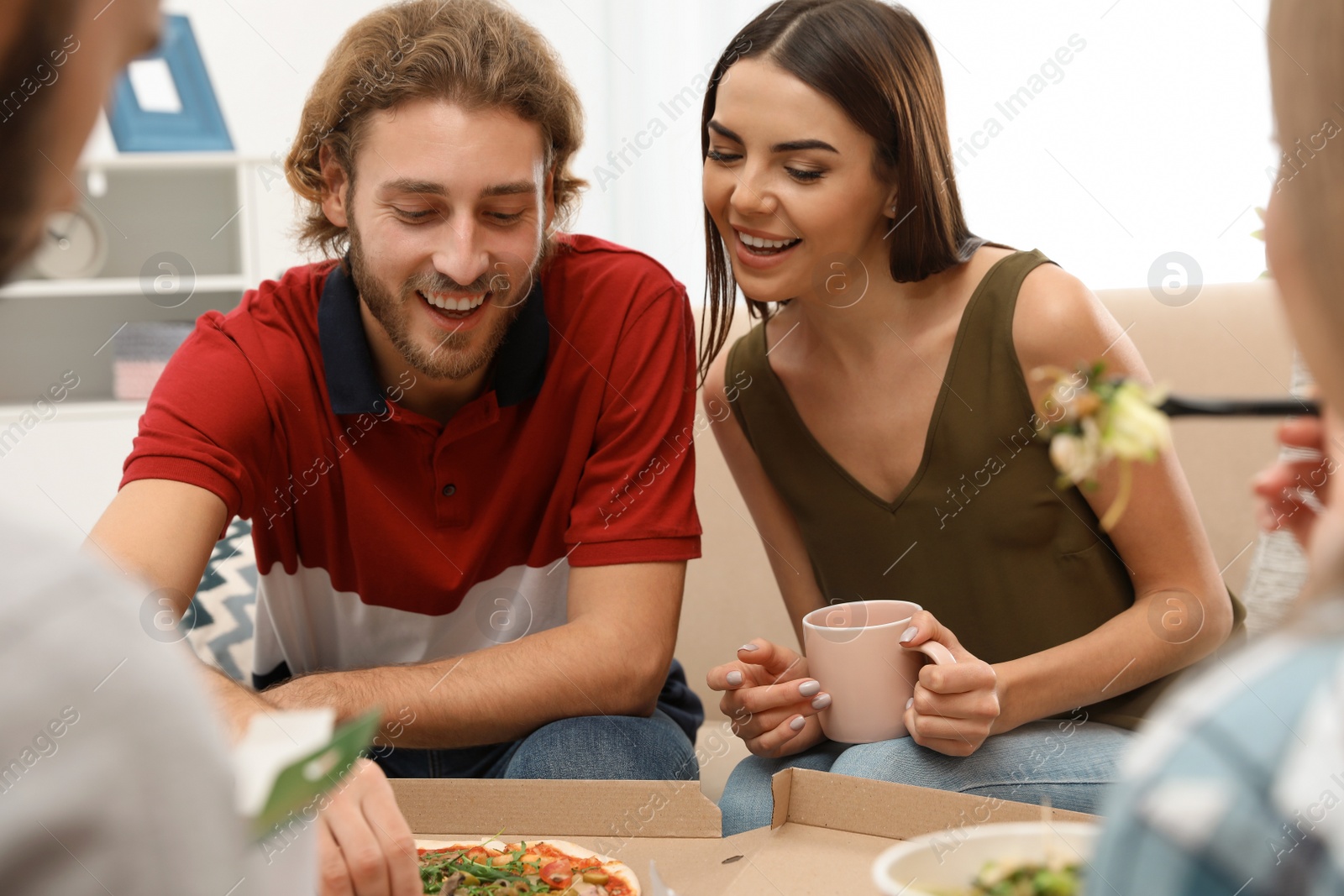 Photo of Young people having lunch together at home. Food delivery