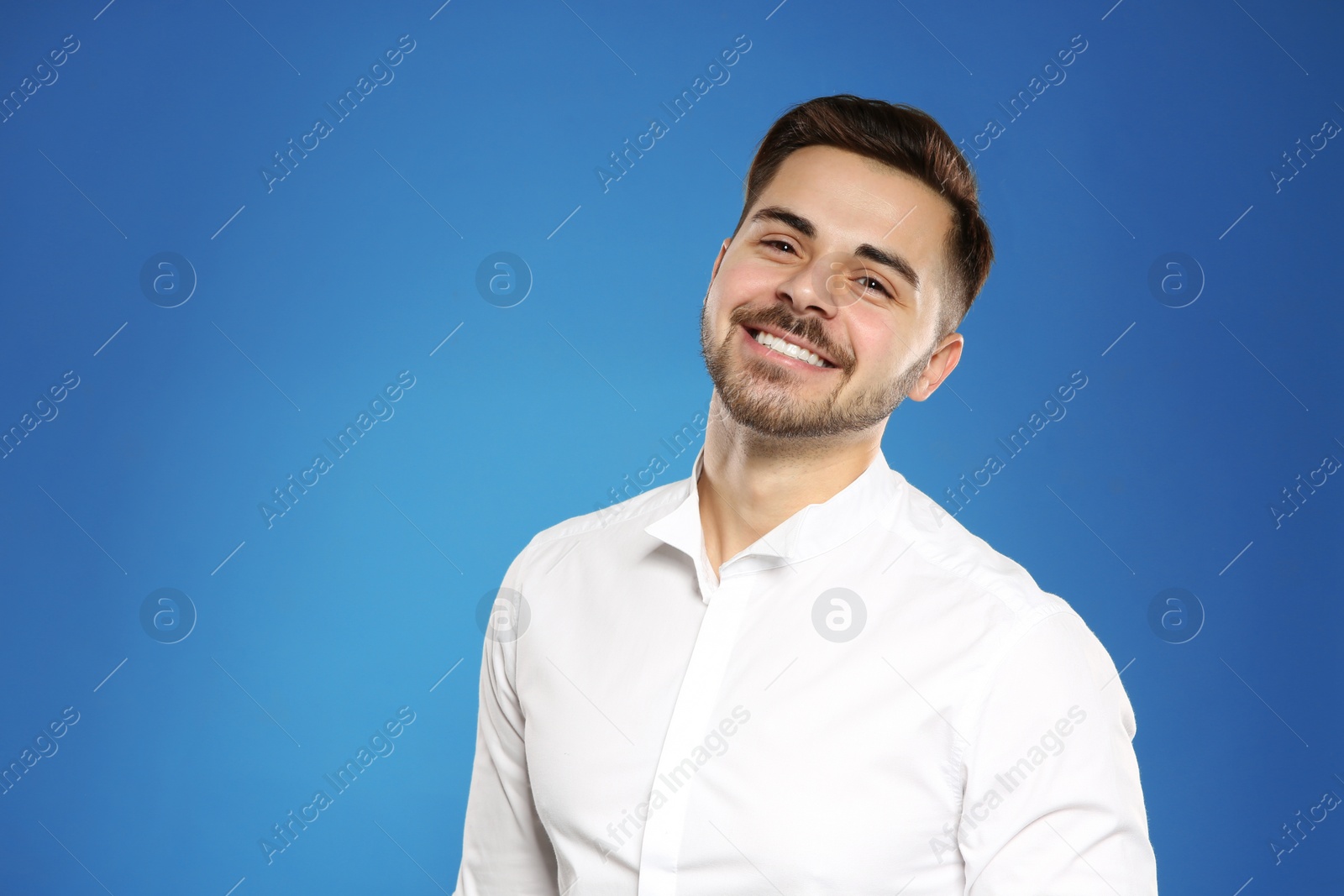 Photo of Portrait of handsome young man on color background