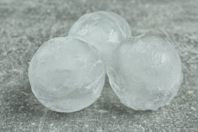 Frozen ice balls on grey table, closeup