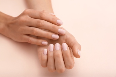 Photo of Closeup view of woman with beautiful hands on color background, space for text. Spa treatment