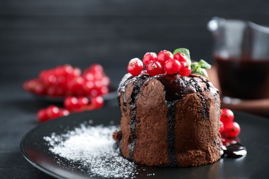 Photo of Delicious warm chocolate lava cake with mint and berries on plate, closeup. Space for text