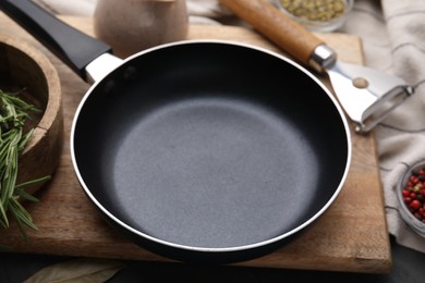 Black frying pan on table, closeup view