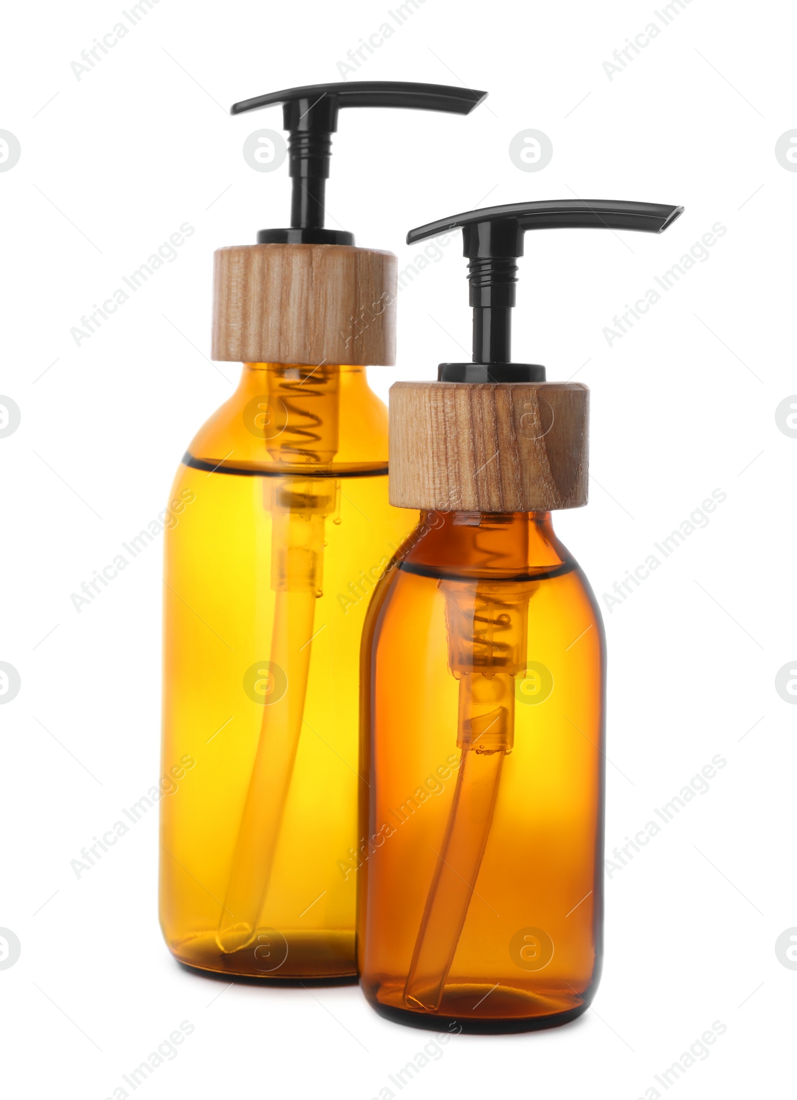 Photo of Bottles with dispenser caps on white background