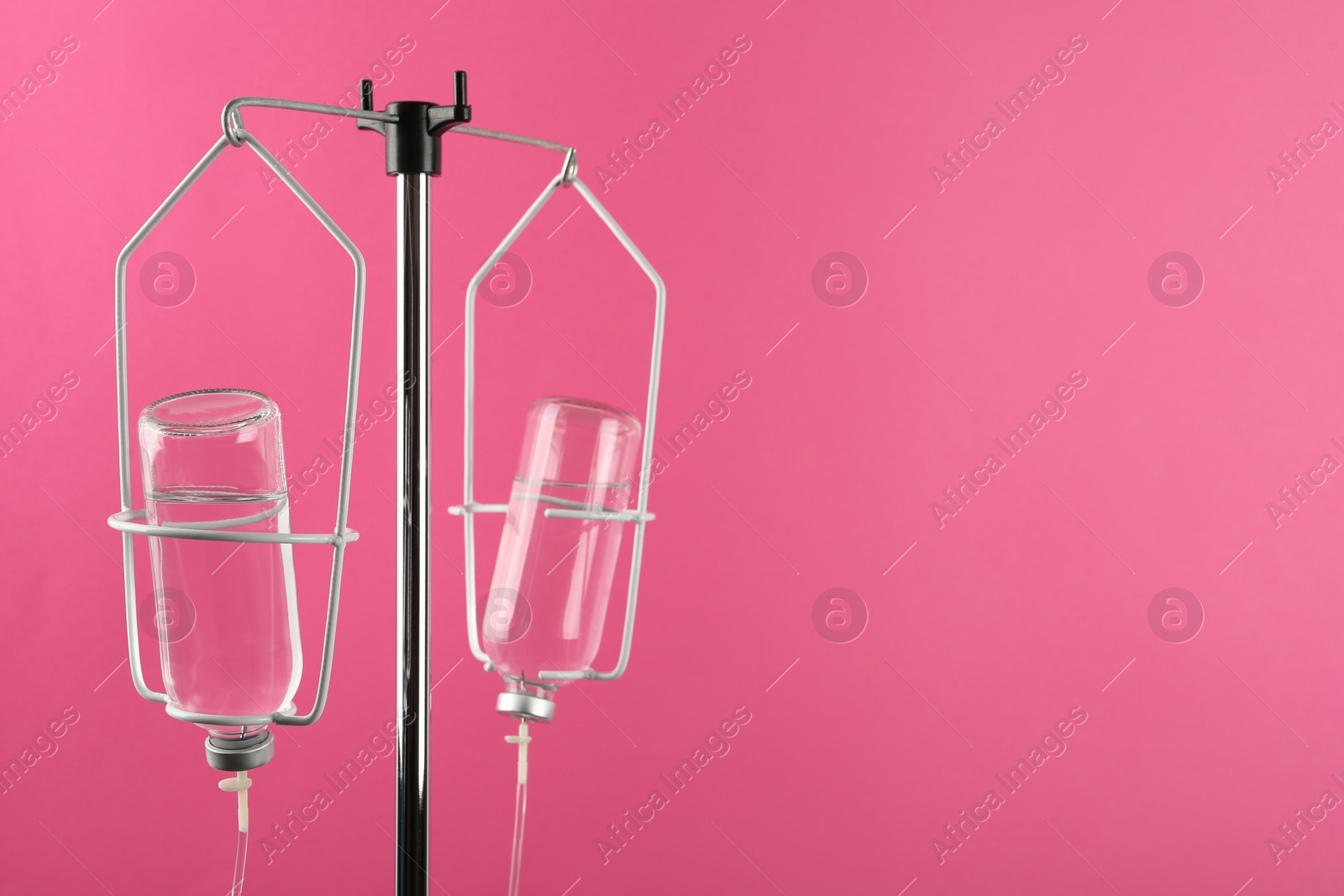 Photo of IV infusion set on pink background. Space for text
