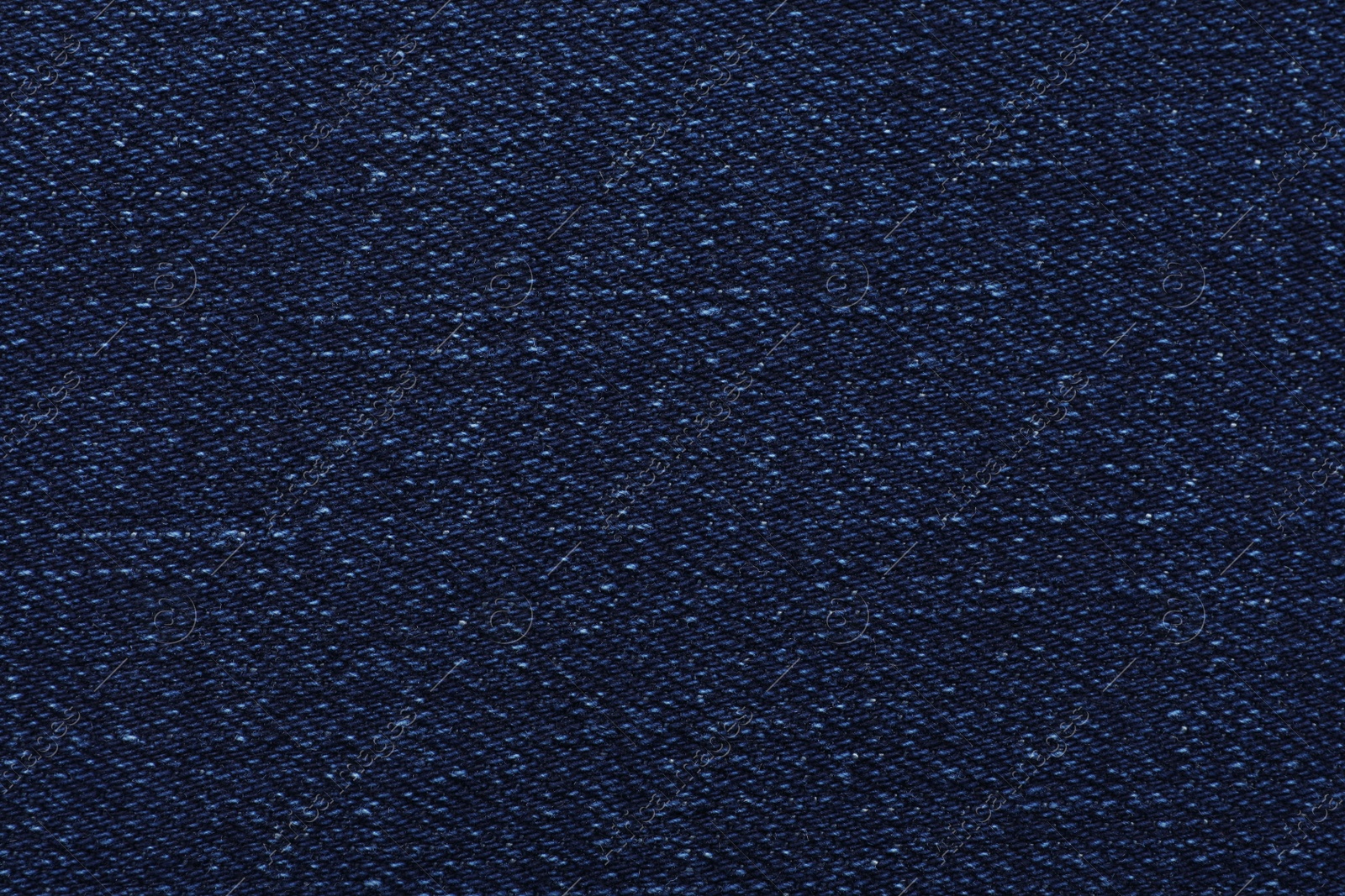 Photo of Texture of dark blue jeans as background, closeup