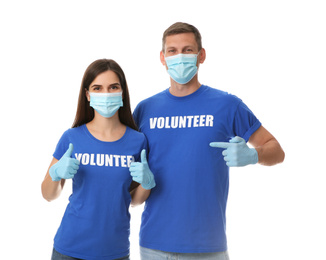 Photo of Volunteers in masks and gloves on white background. Protective measures during coronavirus quarantine