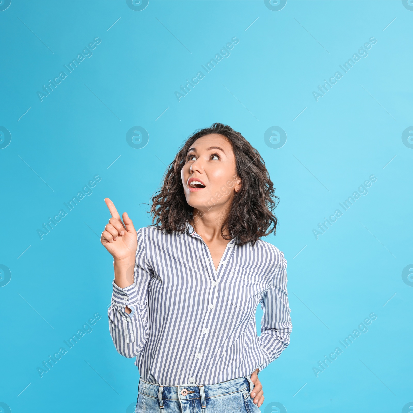 Photo of Thoughtful young woman in casual outfit on blue background