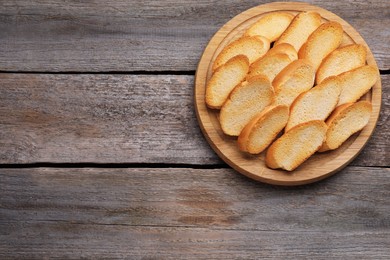 Photo of Tasty hard chuck crackers on wooden table, top view. Space for text