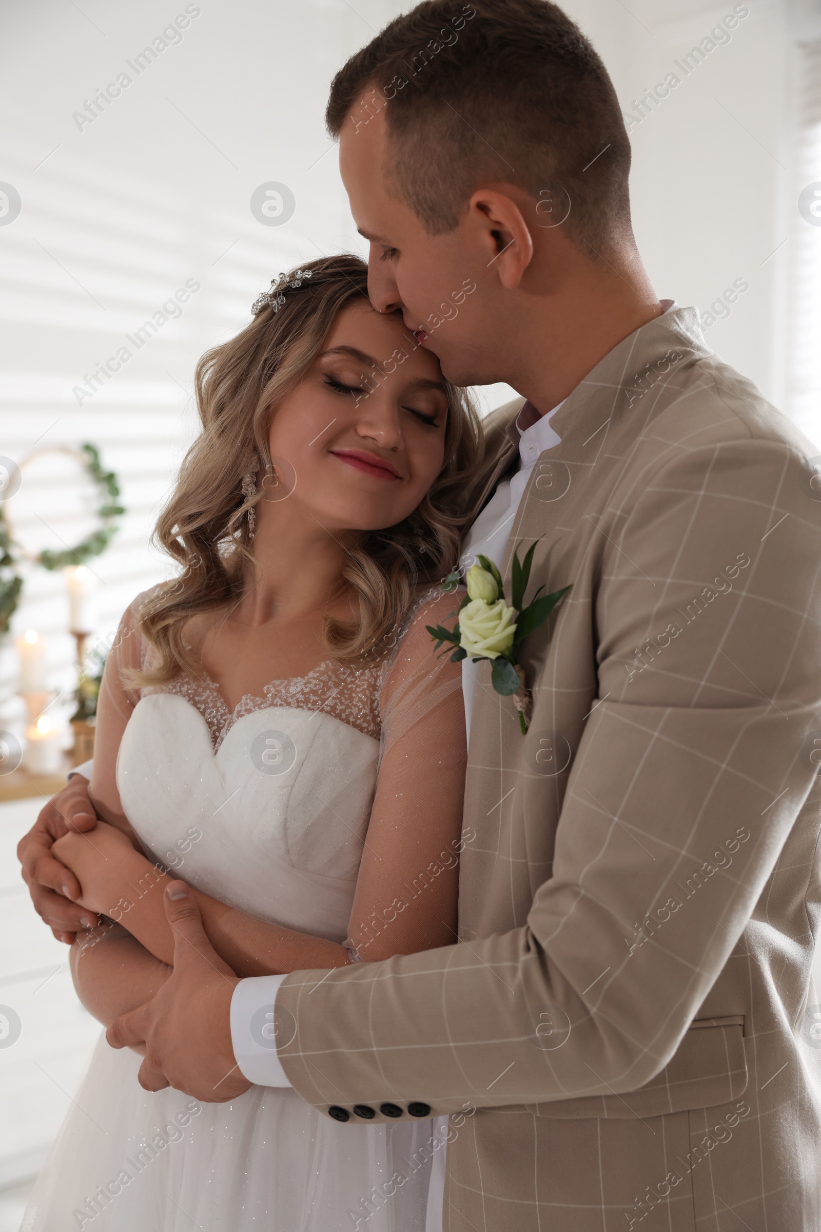 Photo of Happy bride and groom indoors. Wedding day