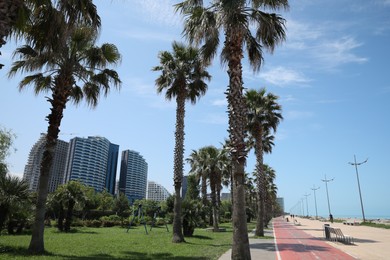 Photo of BATUMI, GEORGIA - JUNE 10, 2022: Cityscape with modern buildings and palm trees