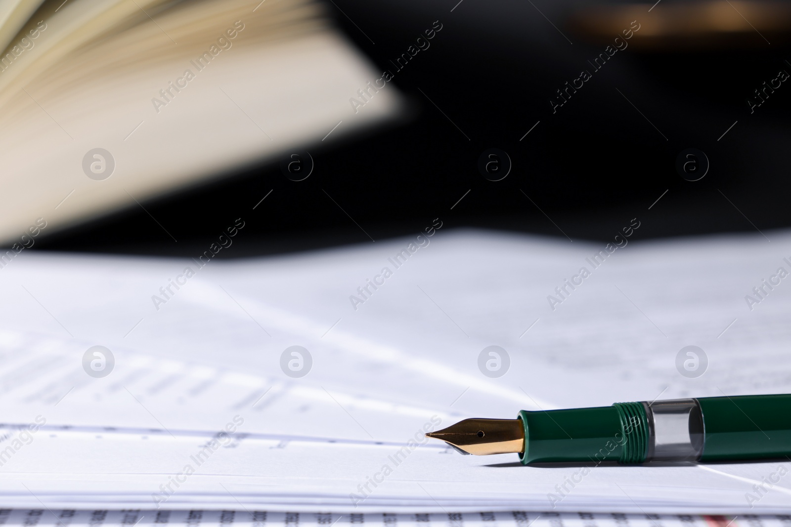 Photo of Fountain pen and paper documents on table, closeup with space for text. Notary service