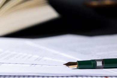 Photo of Fountain pen and paper documents on table, closeup with space for text. Notary service