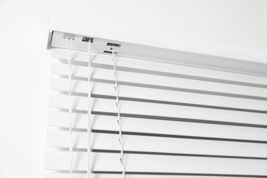 Closeup view of horizontal blinds on window indoors