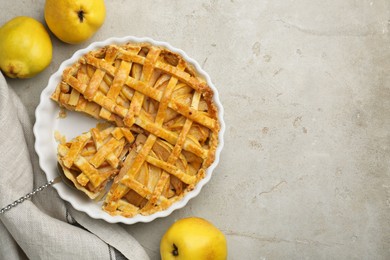 Photo of Tasty homemade quince pie with cake server and fresh fruits on light grey table, flat lay. Space for text
