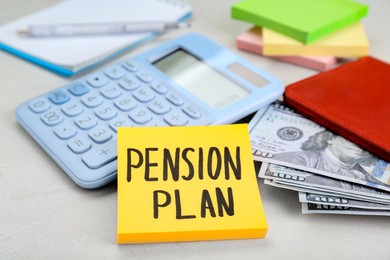 Photo of Note with words Pension Plan, banknotes, calculator and stationery on white table, closeup
